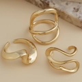 Macro view of minimalist irregular gold lava rings with polished metallic finish - Streamlined Organic Set