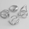 Set of four minimalist silver rings featuring irregular lava and liquid metal textures - Liquid Metal Organic Set