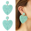 Macro shot of large mint green heart-shaped handmade beaded boho drop earrings - Light Green (NXE05931-9)