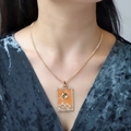 Detail of a vintage sun tarot card necklace with orange enamel and zircon on a gold chain - Orange Sun Pattern (NXN06313)