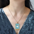 Detail of gold tarot lovers pendant with blue enamel and crystal inlay on necklace - Blue Lovers Pattern (NXN06315)