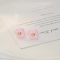Close-up of pink enamel floral stud earrings with a golden center bead on card - Pink (ED81754)