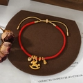 Detailed view of woven red string bracelet with golden horse charm and heart pendant - Adjustable Horse Heart Money Bag Style (SL90329)