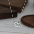 Dettaglio macro della collana in argento con giglio su inserto in madreperla bianca - Stile Argento (XL80477)