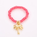 Detailed view of pink beaded summer ring with a golden palm tree charm pendant - One Size / Coconut Tree Charm Style (NXR01576)