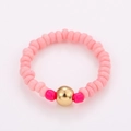 Detail of pink handmade beaded ring set featuring colorful beads and a gold accent bead - One Size / Pink Beads Gold Bead Style (NXR01570)