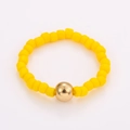 Macro detail of handmade beaded ring featuring yellow matte beads and a gold accent bead - One Size / Yellow Beads Gold Bead Style (NXR01569)