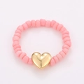 Detail of pink matte beads and a polished golden heart pendant on a stylish stretch ring - One Size / Pink Gold Heart Style (NXR01579)