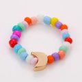 Close-up of colorful handmade beaded ring featuring a golden moon charm on white background - One Size / Moon Charm Style (NXR01547)