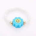 Detail of beaded ring featuring white beads, gold accents, and a blue smile flower design - One Size / White Beads Blue Flower Smiley Style (NXR01548)