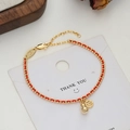 Braided red string bracelet with gold beaded chain and hollowed Fu character charm - Fu Character Disc Gold Ball Style (SL90185)