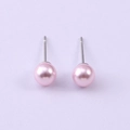 Macro shot of pink round glass pearl studs with silver metal posts on purple background - Pink (NCE07100-6MM)