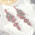 Detailed macro view of pink marquise-cut crystal tassel earrings with leaf-shaped accents - Pink - Silver Base (Style 1)