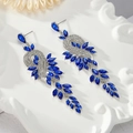 Macro shot of silver tassel earrings with blue marquise cut gems on ceramic plate - Blue - Silver Base (Style 2)