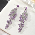 Detailed macro view of punk style 3D human-shaped earrings with purple gems and silver finish - Purple - Silver Base (Style 7)