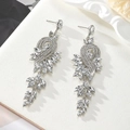 Macro shot of silver metal chandelier earrings with sparkling marquise crystal tassels - White - Silver Base (Style 8)
