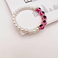 Detail of baroque pearls and pink evil eye beads with golden crystal spacers on a bracelet - Rose Red