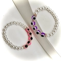Macro detail of baroque pearl bracelets with evil eye beads and sparkling spacers - Light Purple