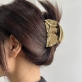 Lava textured golden metal hair claw clip with mirror finish on brunette hair - Wave Crescent Style (WXF07201)