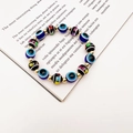 Detail of bohemian evil eye stretch bracelet with colorful beads and gold metal spacers - Geometric Painted With Evil Eye (Style 3)