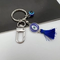 Detail of Turkish Evil Eye keychain with blue enamel pendant and dark blue silk tassel - Silver Tassel Blue Eye Style 9