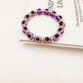 Detail of purple Evil Eye beads and gold spacers on a stylish stretch bracelet - Purple