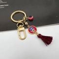 Detail of Hamsa Hand keychain with red enamel, crystal accents and deep red tassel charm - Hamsa Hand Red Tassel Style 11
