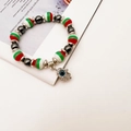 Detail of Hamsa Hand and Evil Eye charm on a red, white, and green beaded elastic bracelet - Red White Green Striped With Hamsa (Style 2)