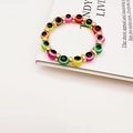 Colorful Evil Eye beaded bracelet with gold spacers on a minimalist white background - Multi-color