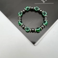 Close-up of elastic bracelet with green evil eye beads and black hematite stones - Dark Green