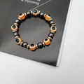Hämatit-Armband mit bösem Blick, orangefarbenen Perlen und silbernen Zwischenstücken - Orange
