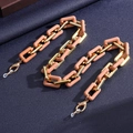 Detail of gold metal and pink acrylic chain links with silicone anti-slip rings - Color Four
