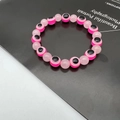 Detail of pink evil eye beads and translucent round stones on a beaded bracelet - 10mm / Pink (2)