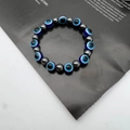 Macro view of blue evil eye beads and grey hematite stones on a beaded elastic bracelet - 10mm / Blue (6)