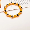 Detail of beaded evil eye bracelet featuring orange motifs and translucent yellow beads - 10mm / Orange Yellow (7)