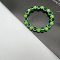 Detailed macro view of green evil eye and agate patterned beads on an elastic bracelet - 10mm / Emerald Green(10)
