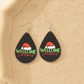 Macro detail of wooden teardrop earrings with Welcome Christmas print and red Santa hat - Welcome Santa Hat Style (3)