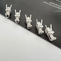 Detailed macro view of five polished silver alloy dragon head charms for jewelry making - Thick Silver