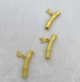 Macro view of matte gold bamboo-shaped jewelry connectors with delicate leaf charms - Matte Gold