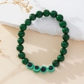 Handmade beaded bracelet featuring dark green stones and green Evil Eye glass beads - Green Spotted Stone
