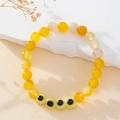 Handmade beaded bracelet with yellow natural stones and blue Turkish evil eye charms - Yellow Agate Style