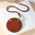 Close-up of brown PU leather round organizer pouch with stitching and silver button details - Amber Round Style