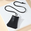 Detail of black leather storage pouch with white contrast stitching and silver hardware - Black Trapezoid Style