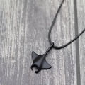 Punk manta ray pendant necklace with black matte finish on a leather cord over wood - Black