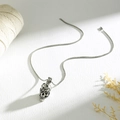 Macro shot of punk style silver skull pendant with snake detailing and sturdy box chain - Skull Entwined with Snake Style (XN660)