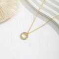 Detail shot of golden heart pendant featuring double rows of sparkling crystals on a chain - Hollow Heart Ring Style (XE481-2) / Gold