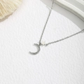 Close-up of silver crescent moon pendant with crystals and star on white texture - Moon and Star Pendant Style (XE481-3) / Silver