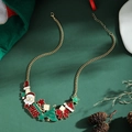 Golden Christmas themed necklace featuring colorful oil-drip Santa and tree charms - Necklace