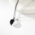 Detail view of heart-shaped magnetic necklaces with black and white enamel and portrait art - Style 4 (Portrait Line Heart)