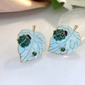 Enamel ladybug on blue leaf stud earrings with green rhinestones and golden frame - Lake Blue